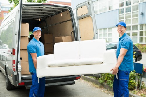 Professional movers handling flat removals in Wandsworth outside an apartment building