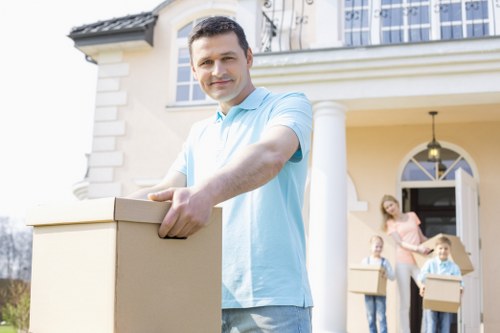 Mover carrying a boxed item with care during a relocation